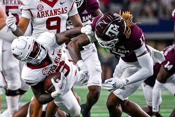 Sep 24, 2022; Arlington, Texas, USA; Arkansas Razorbacks running back Rashod Dubinion (6) is thrown to the ground by Texas A&M Aggies defensive back Jaylon Jones (17) during the second half at AT&T Stadium. Mandatory Credit: Jerome Miron-USA TODAY Sports